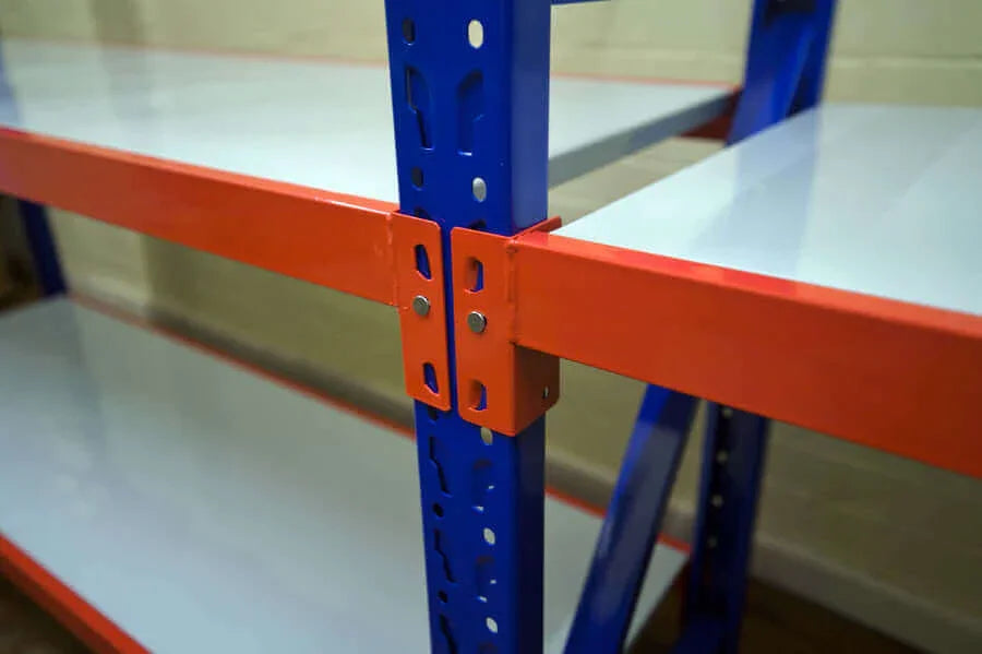 Blue metal warehouse shelving unit with orange horizontal support beams and white shelves