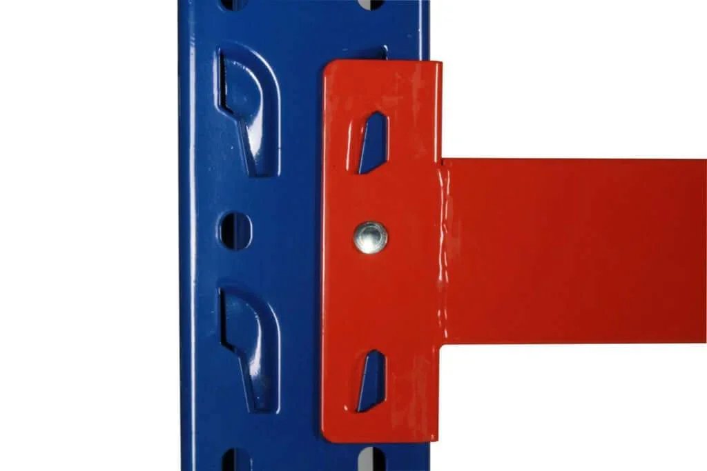 Close-up of blue vertical steel shelving frame with red horizontal metal beam attachment in industrial warehouse