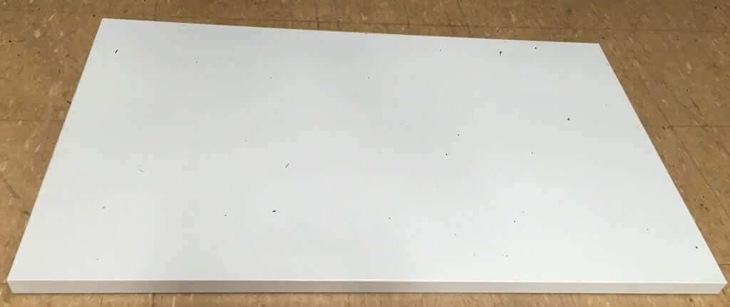 White rectangular heavy duty extra deck shelf panel for Falcon long span shelving on tan floor